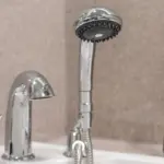 Photo of handheld shower head held in place by rack
