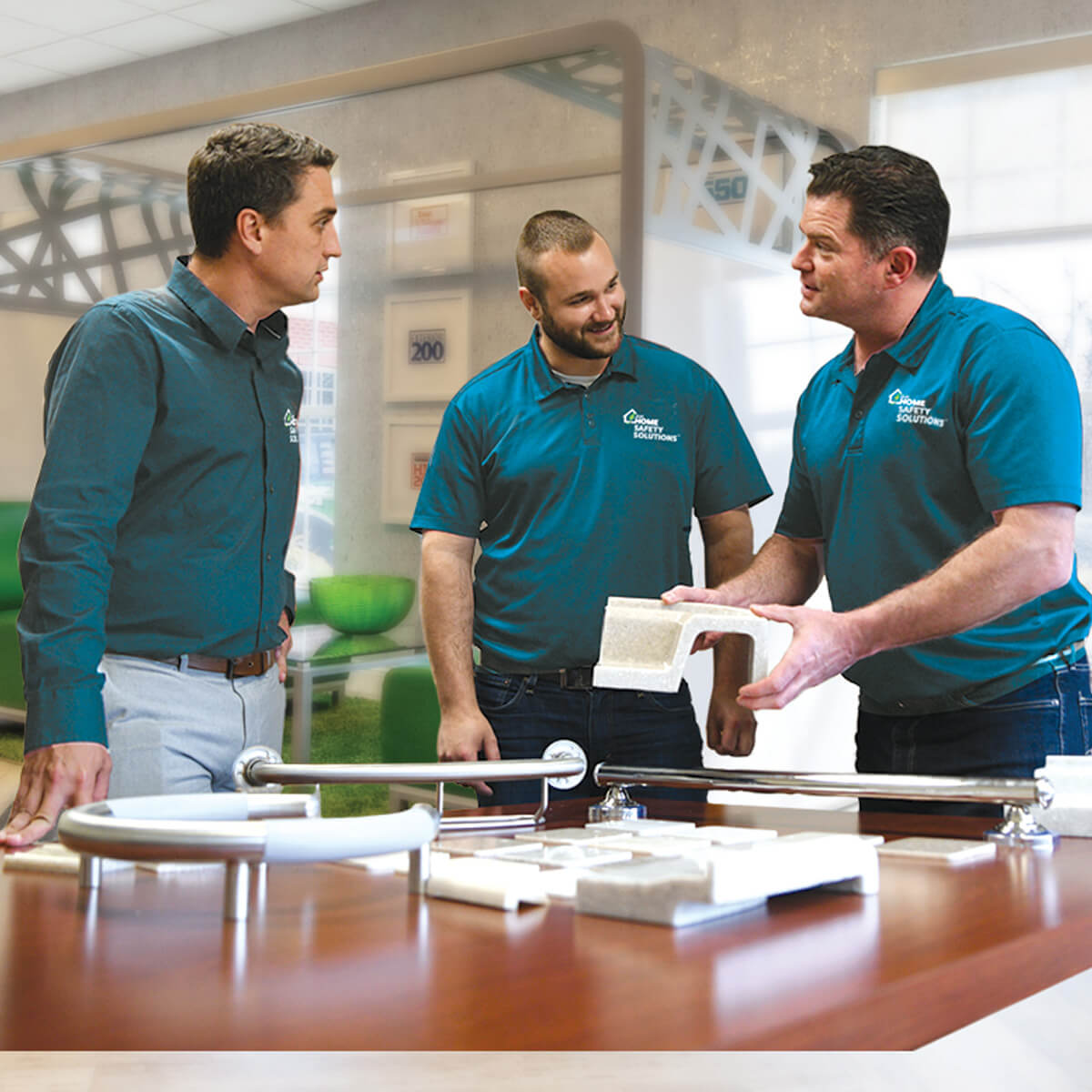 Three LHSS employees reviewing product demonstrations