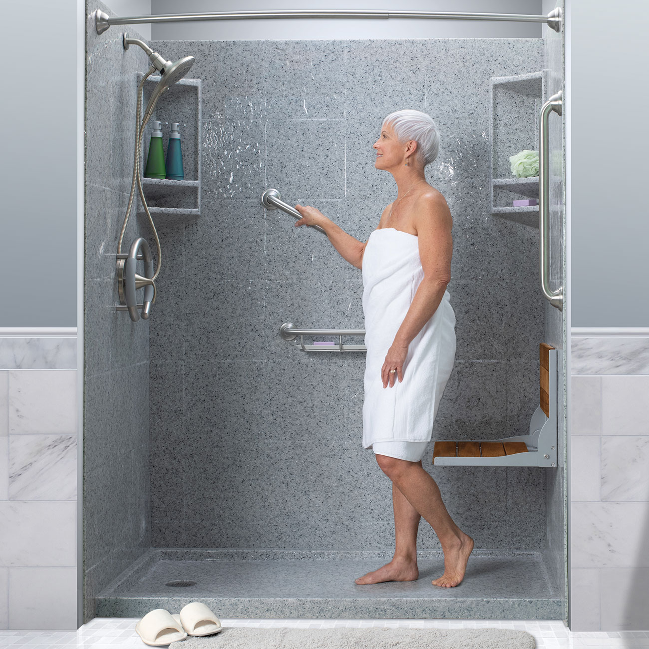 Photo of woman standing in the walk in shower and using the grab bar