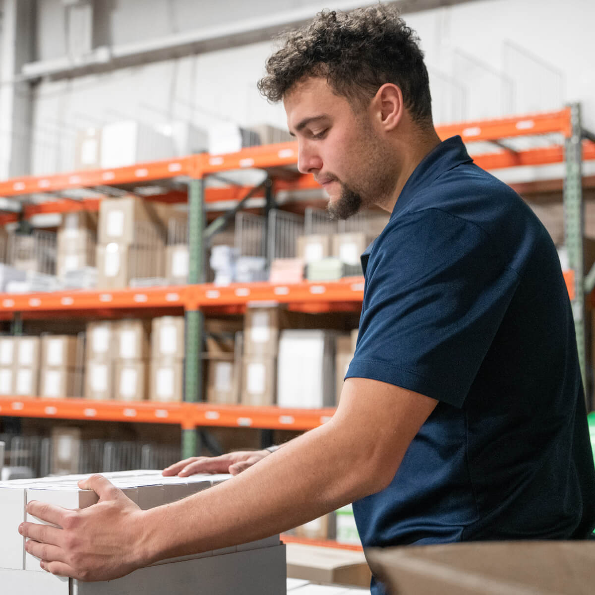 LHSS employee in warehouse sorting out products