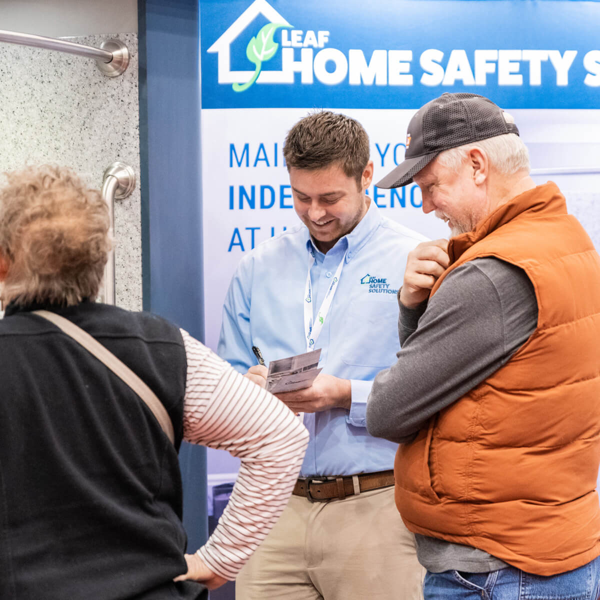 LHSS employee speaking with potential customers at an event