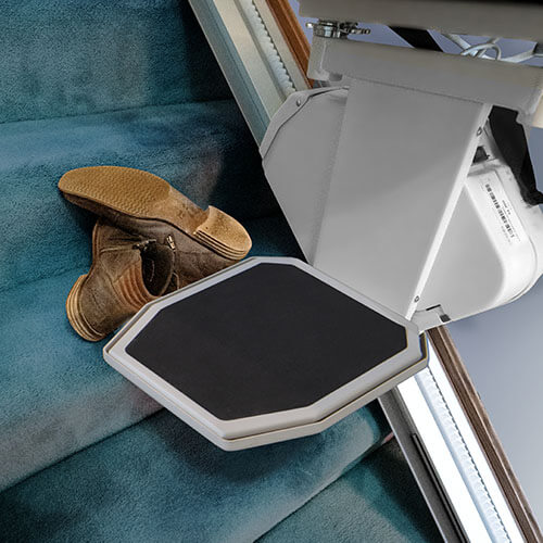 stair lift and obstruction sensors beside a boot on stairways